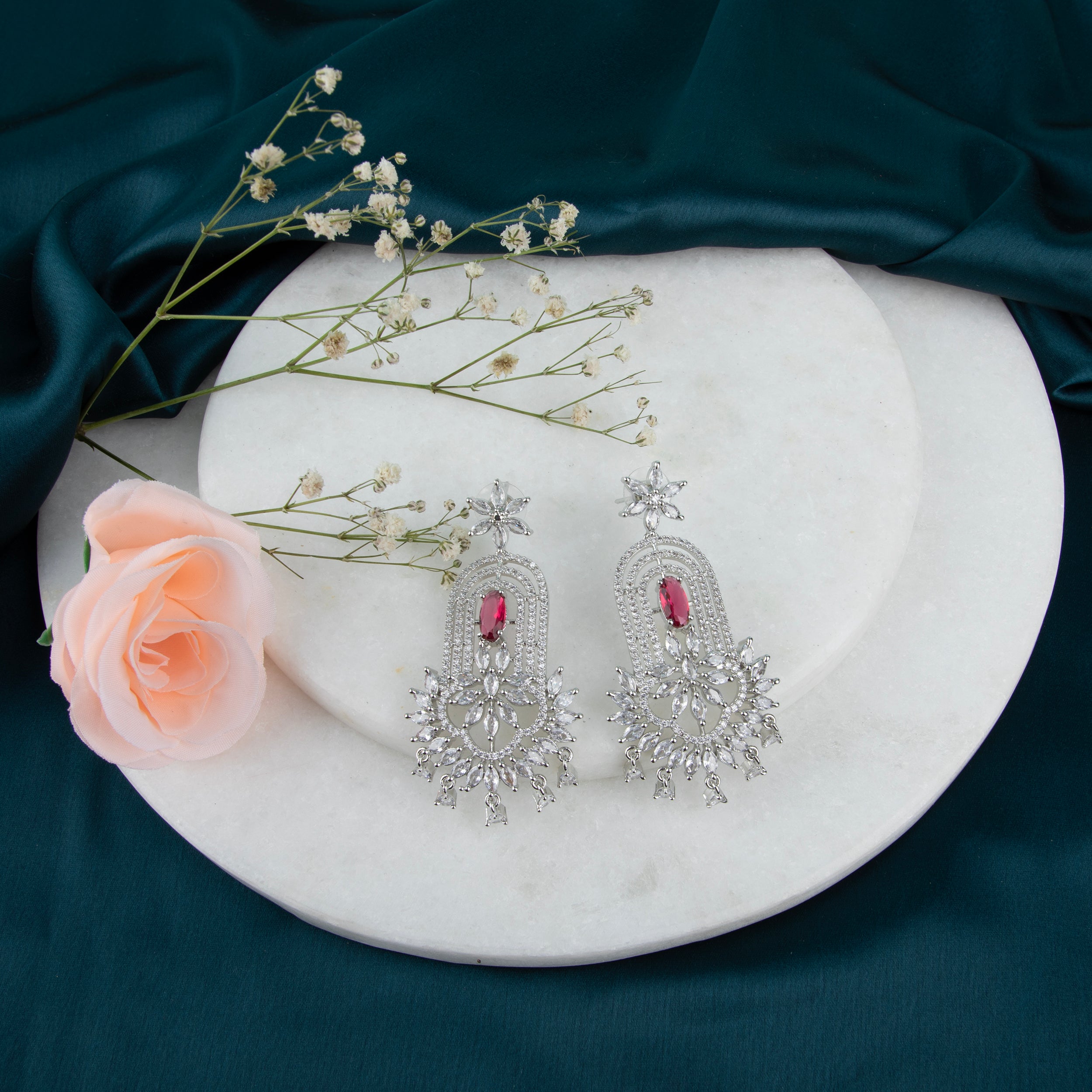 chandelier-style earrings with intricate detailing and a cascade of shimmering crystals.