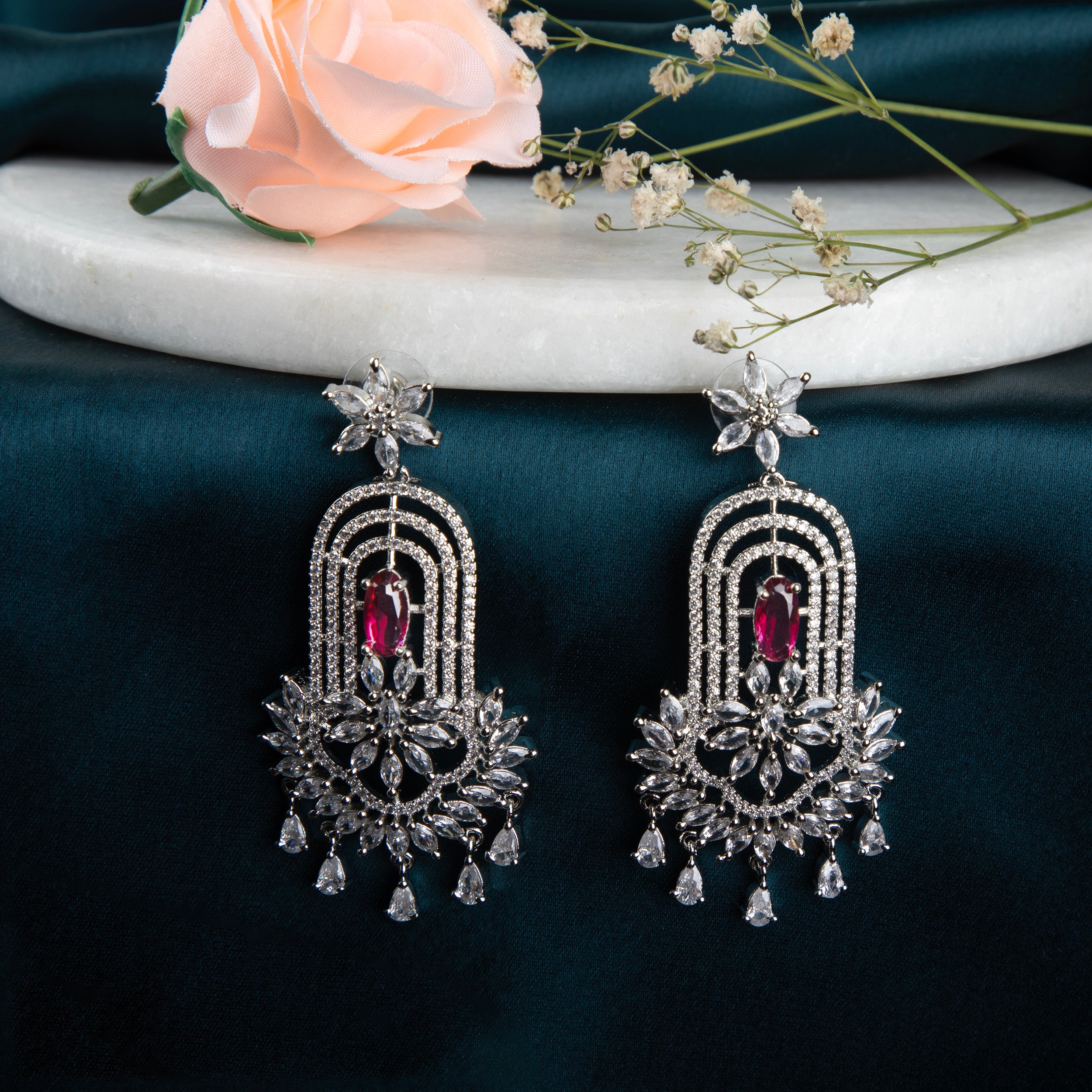 chandelier-style earrings with intricate detailing and a cascade of shimmering crystals.
