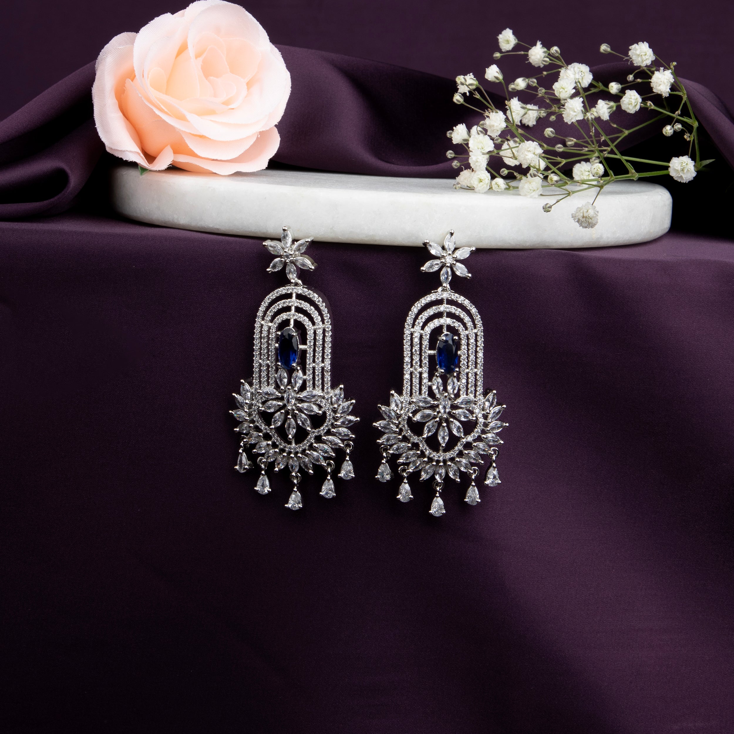 chandelier-style earrings with intricate detailing and a cascade of shimmering crystals