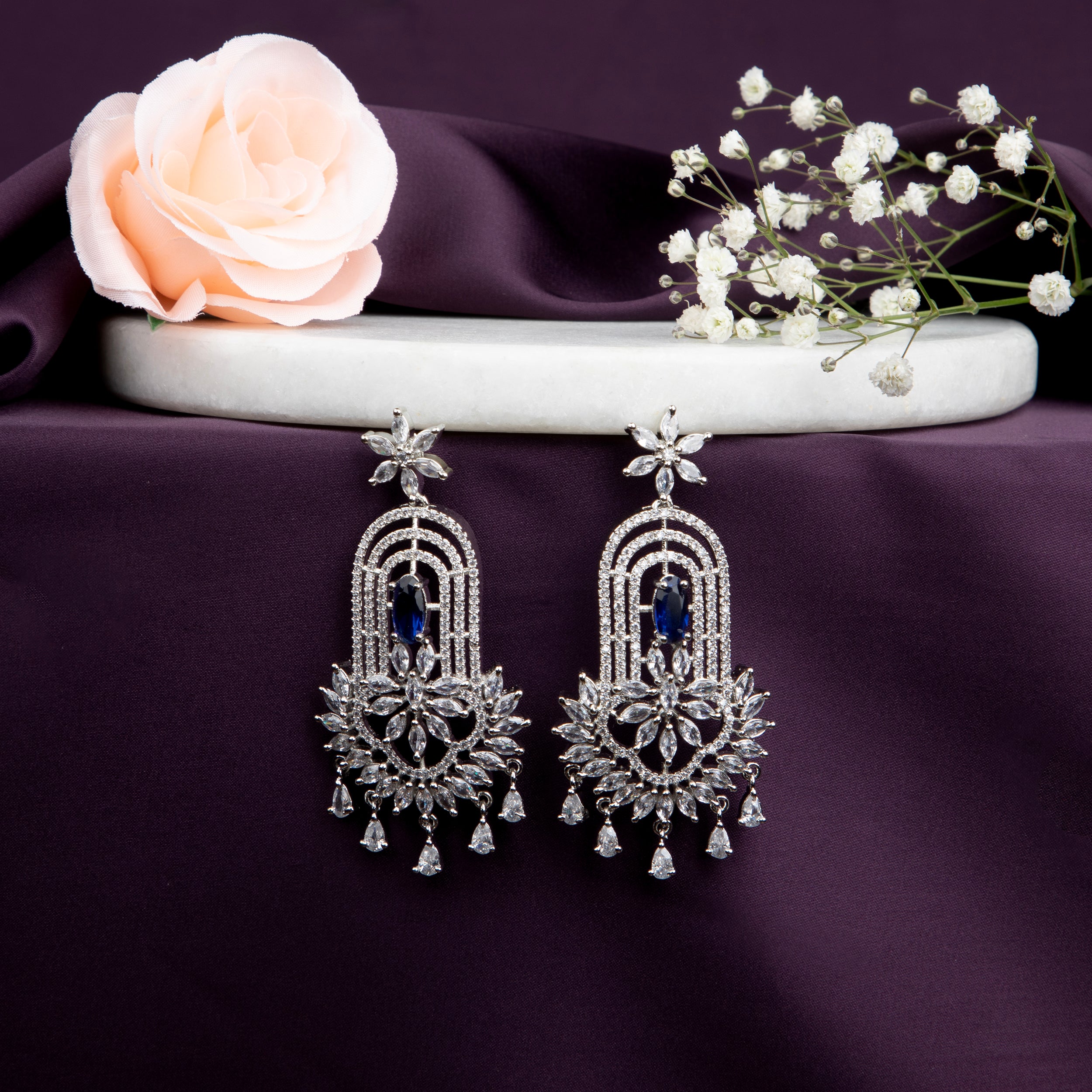 chandelier-style earrings with intricate detailing and a cascade of shimmering crystals