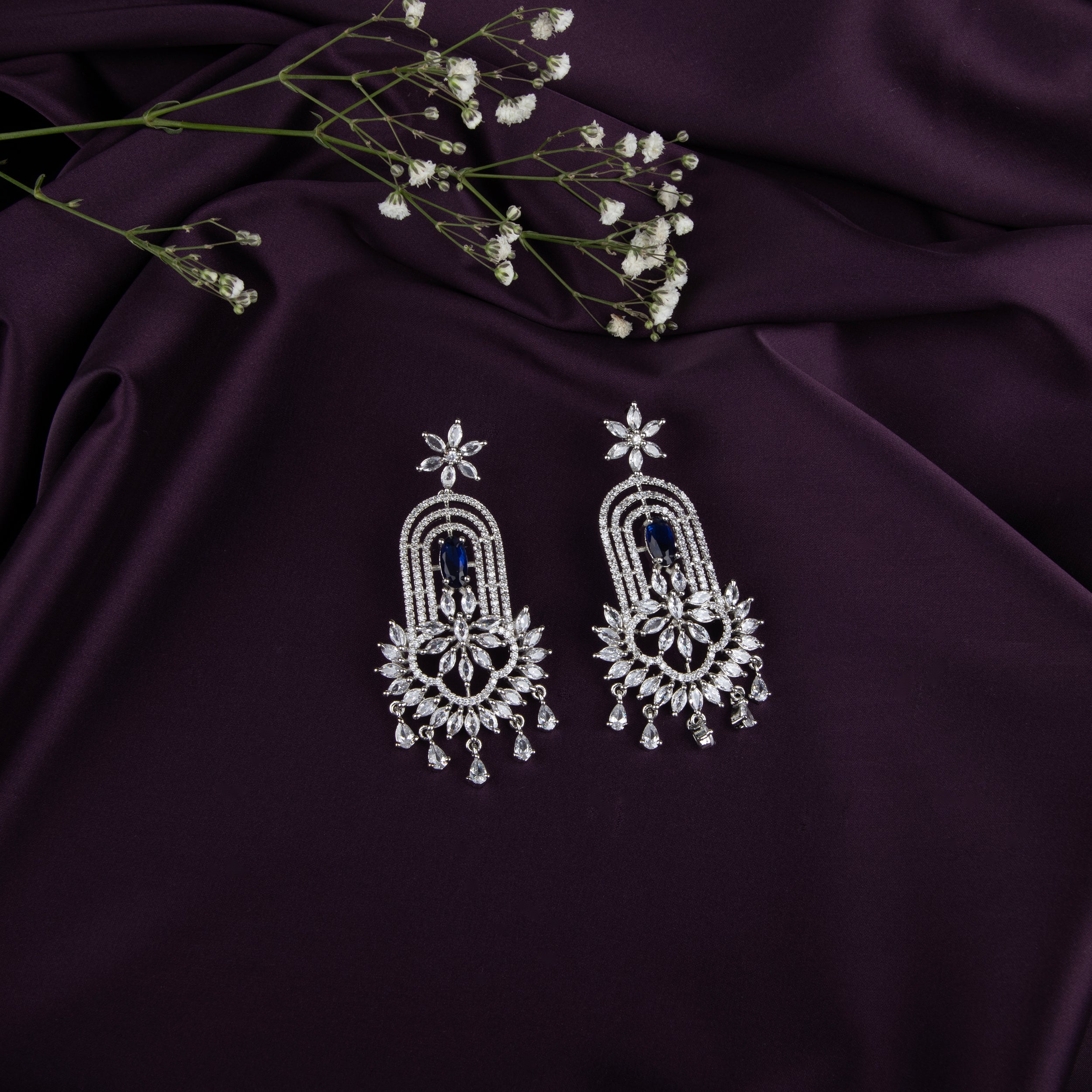 chandelier-style earrings with intricate detailing and a cascade of shimmering crystals