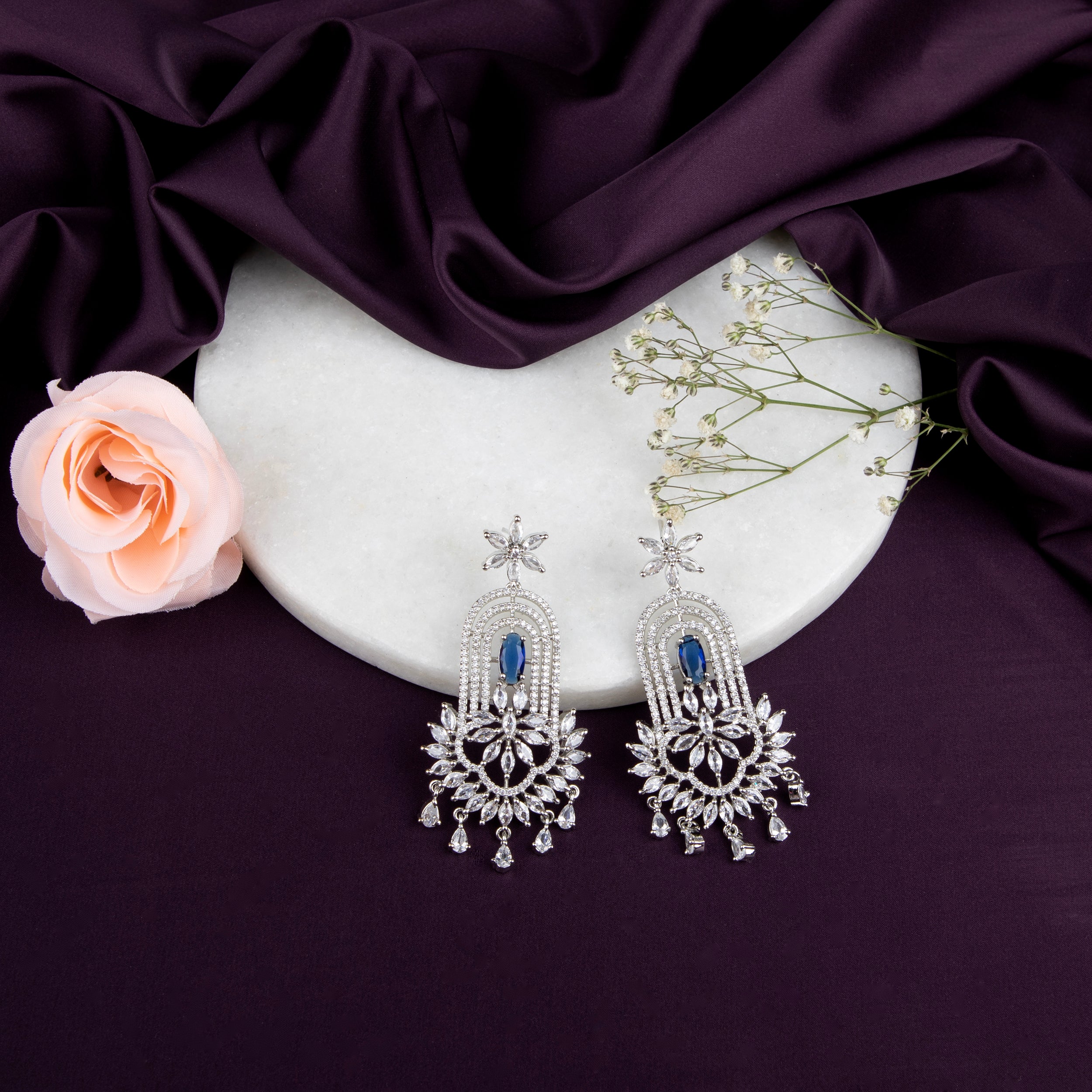 chandelier-style earrings with intricate detailing and a cascade of shimmering crystals