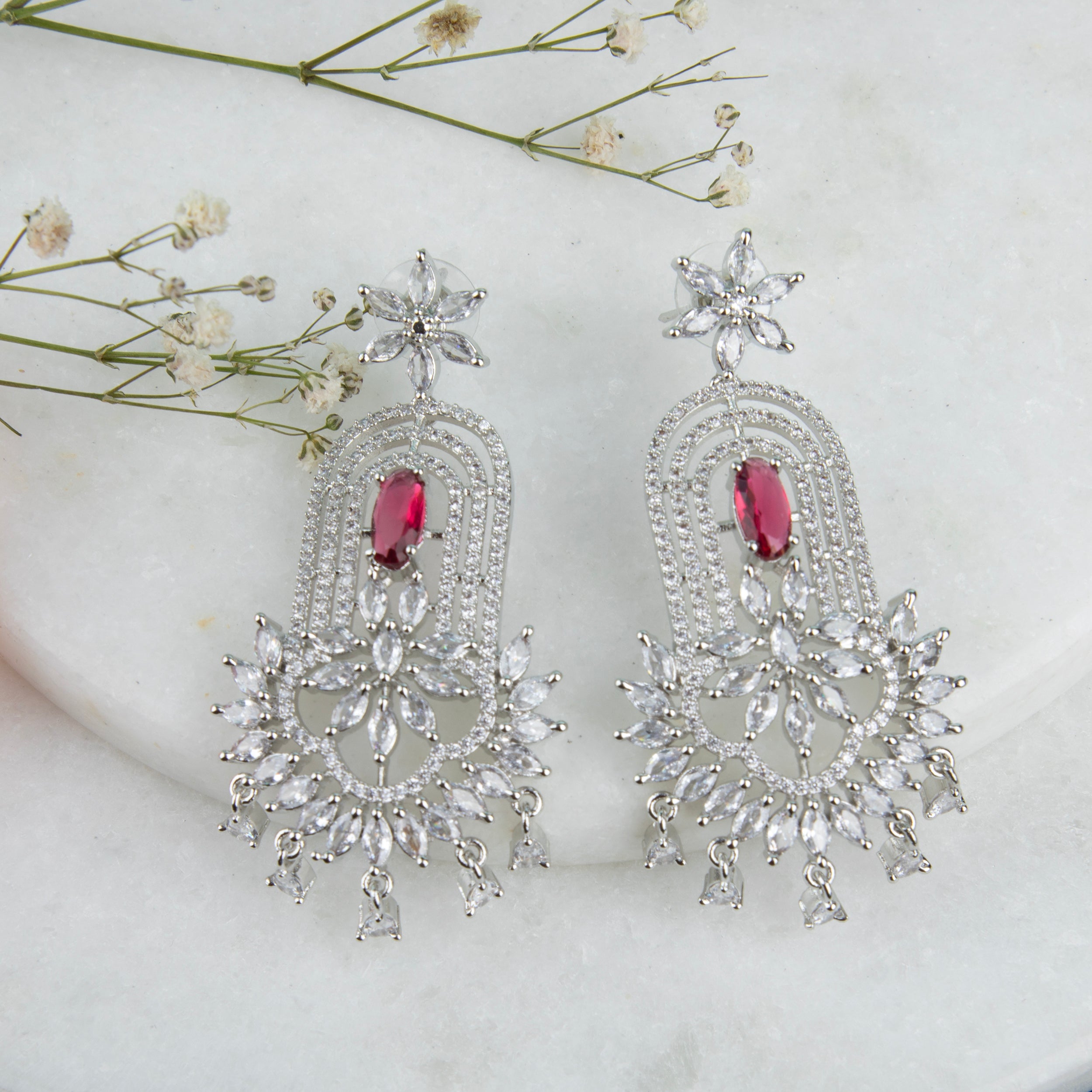 chandelier-style earrings with intricate detailing and a cascade of shimmering crystals.