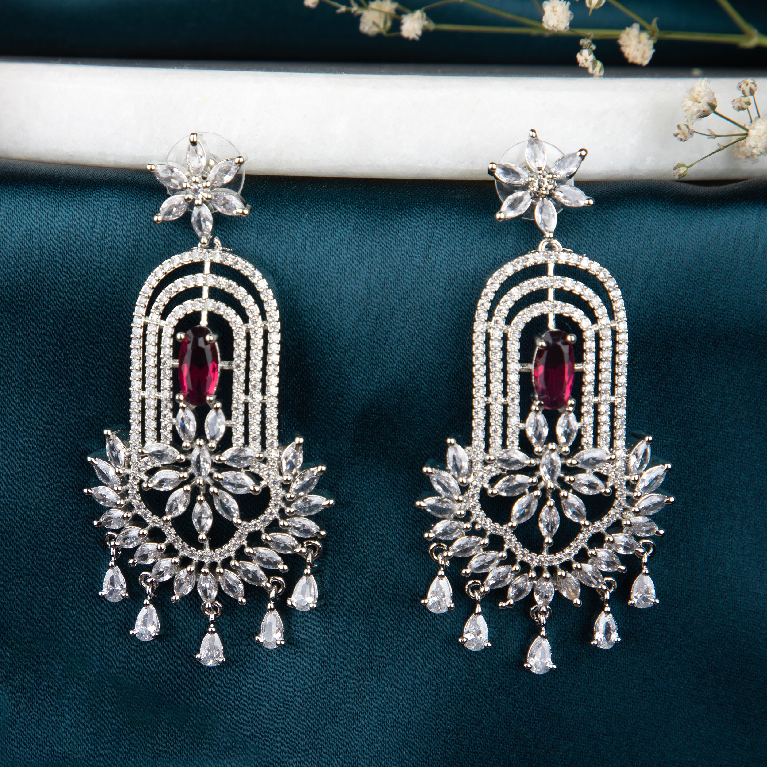 chandelier-style earrings with intricate detailing and a cascade of shimmering crystals.