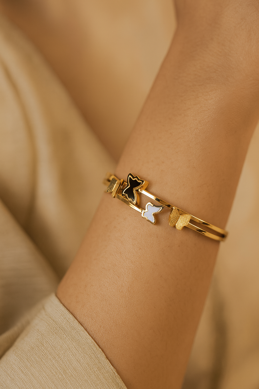 LA FILLE D'OR Gold-Plated Butterfly Bracelet with Black and White Enamel Design